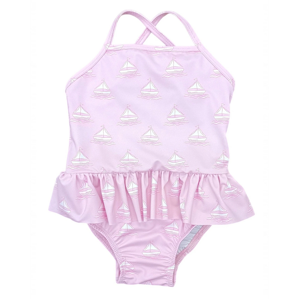 That Store girls pink one-piece swimsuit featuring a white sailboat print and a ruffled skirted waist.