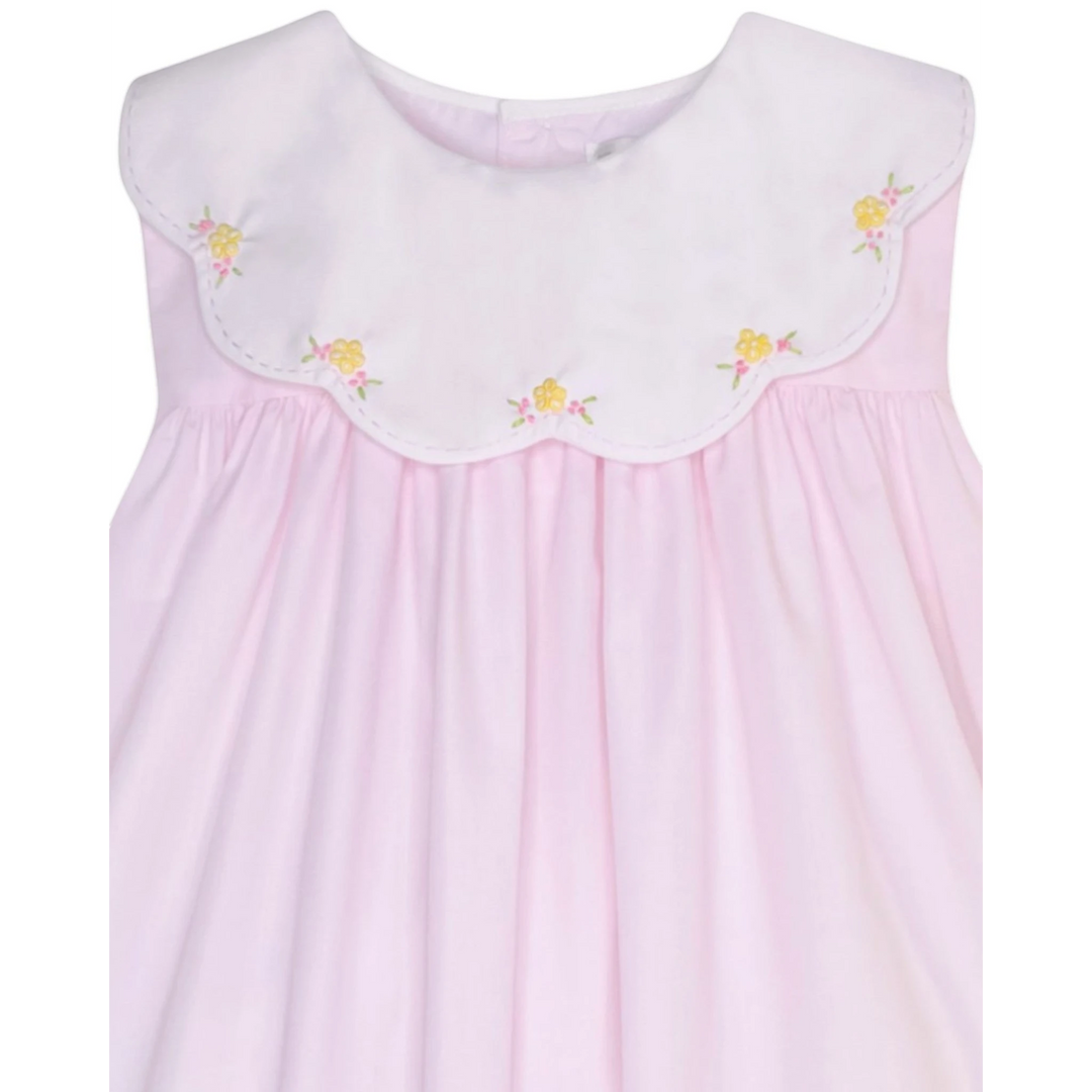 That Store pink dress with a white scalloped collar and delicate yellow and pink embroidered floral details.