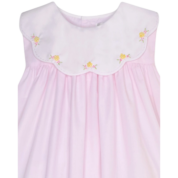 That Store pink dress with a white scalloped collar and delicate yellow and pink embroidered floral details.