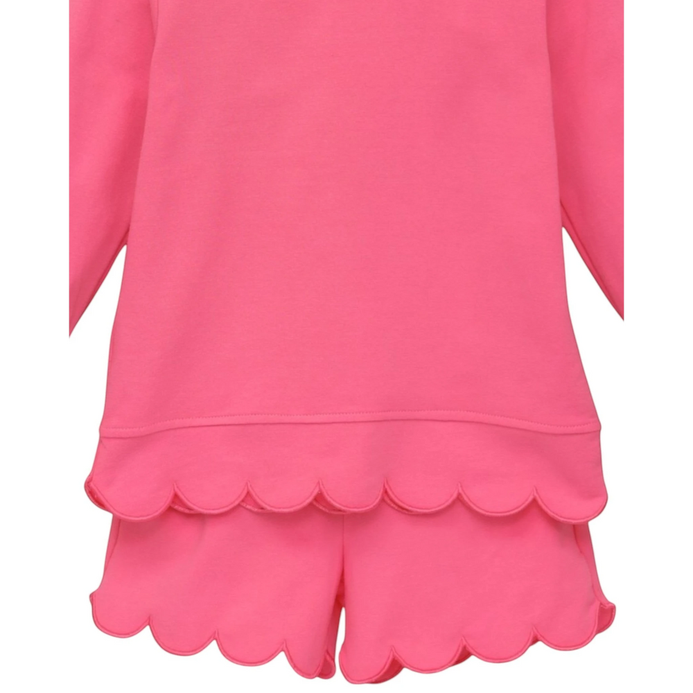 That Store pink two-piece girls set featuring a long-sleeve top and shorts with delicate scalloped edges.