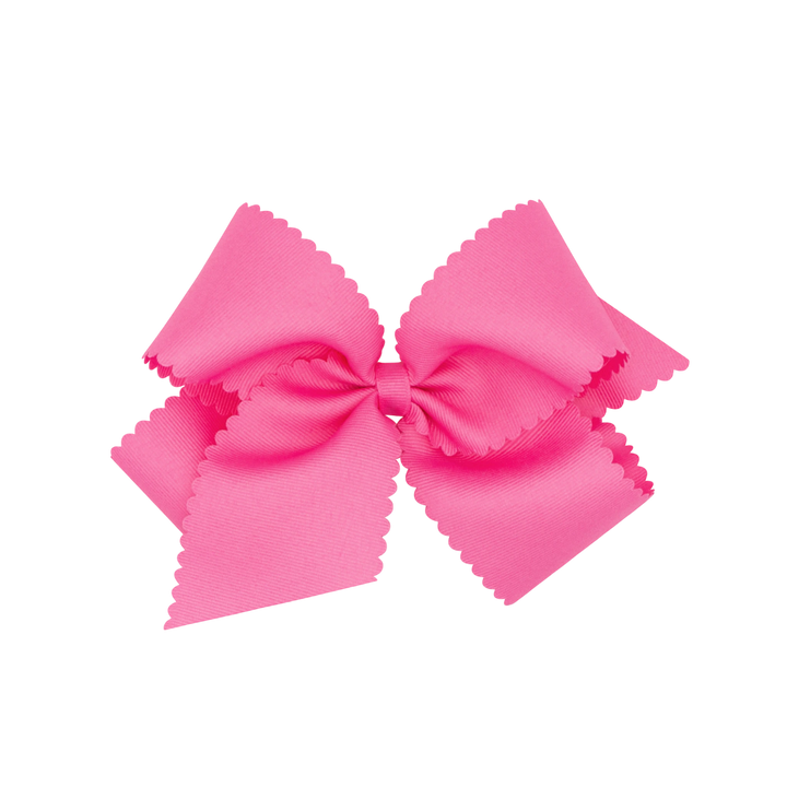 That Store bright pink grosgrain hair bow for girls featuring a decorative scalloped edge and secure clip
