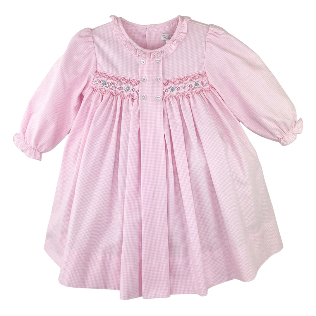 That Store pink micro check long sleeve dress with smocked panel, delicate embroidery, and decorative front buttons.