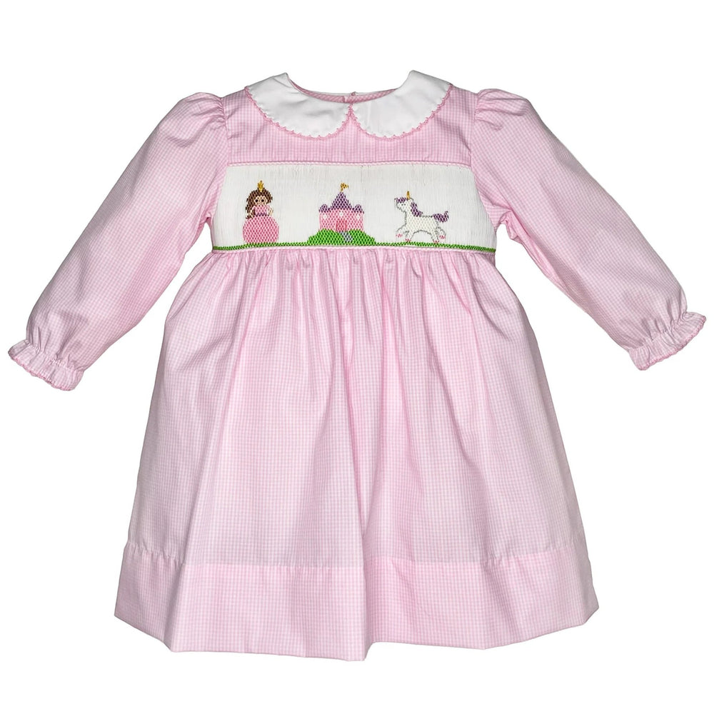 That Store pink gingham dress with hand-smocked fairytale scene, peter pan collar, and long sleeves.