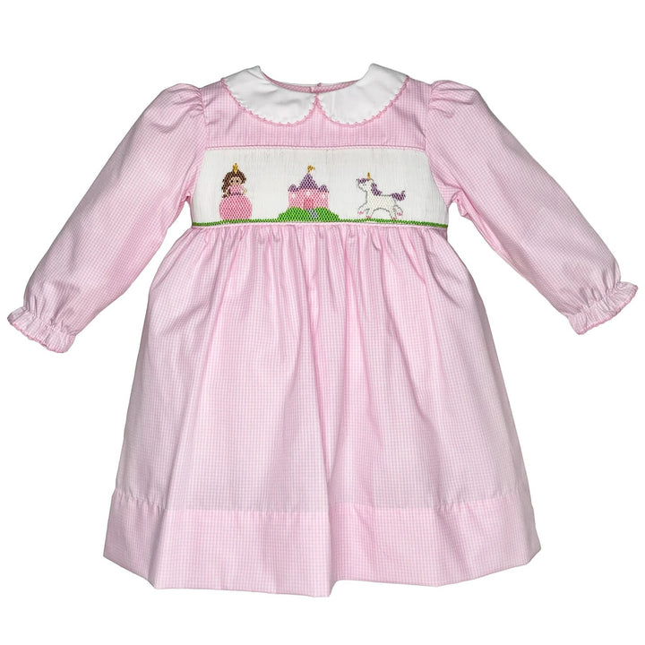 That Store pink gingham dress with hand-smocked fairytale scene, peter pan collar, and long sleeves.
