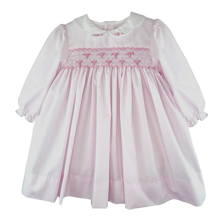 That Store girls pink dress with corded smocking, rosette details, and a white scalloped embroidered collar.