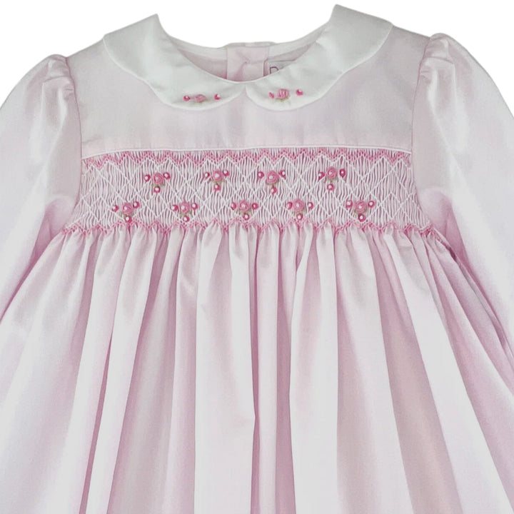 That Store girls pink dress with corded smocking, embroidered rosette details, and a white scalloped collar.