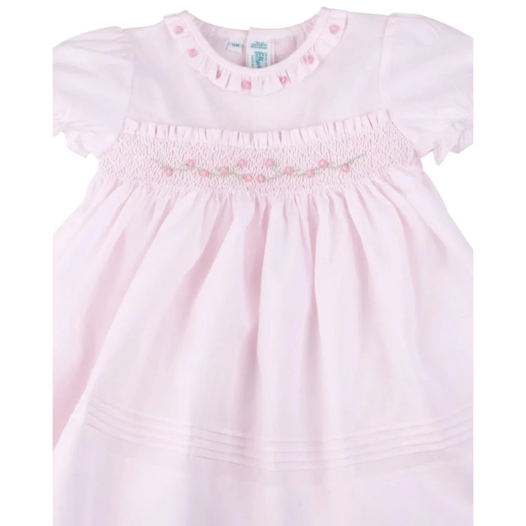 That Store Rose Garden Collection pink dress with hand-smocked bodice, rosebud embroidery, and ruffled neckline.