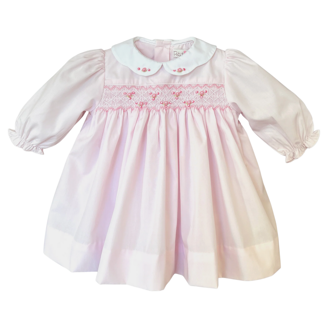 That Store girls pink dress with corded smocking, rosette details, and a white scalloped embroidered collar.