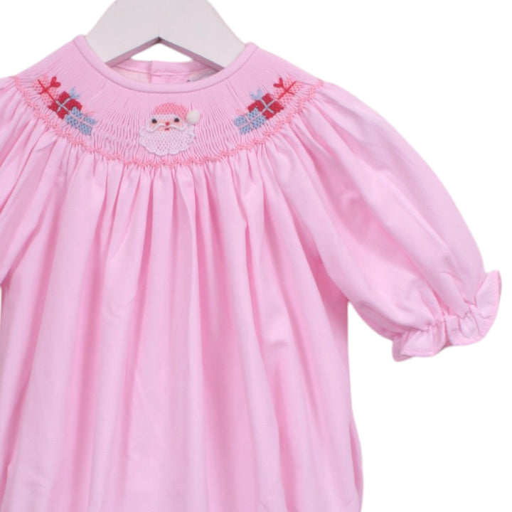 That Store pink girls bubble featuring smocked Santa Claus and gift embroidery with puff sleeves for Christmas.