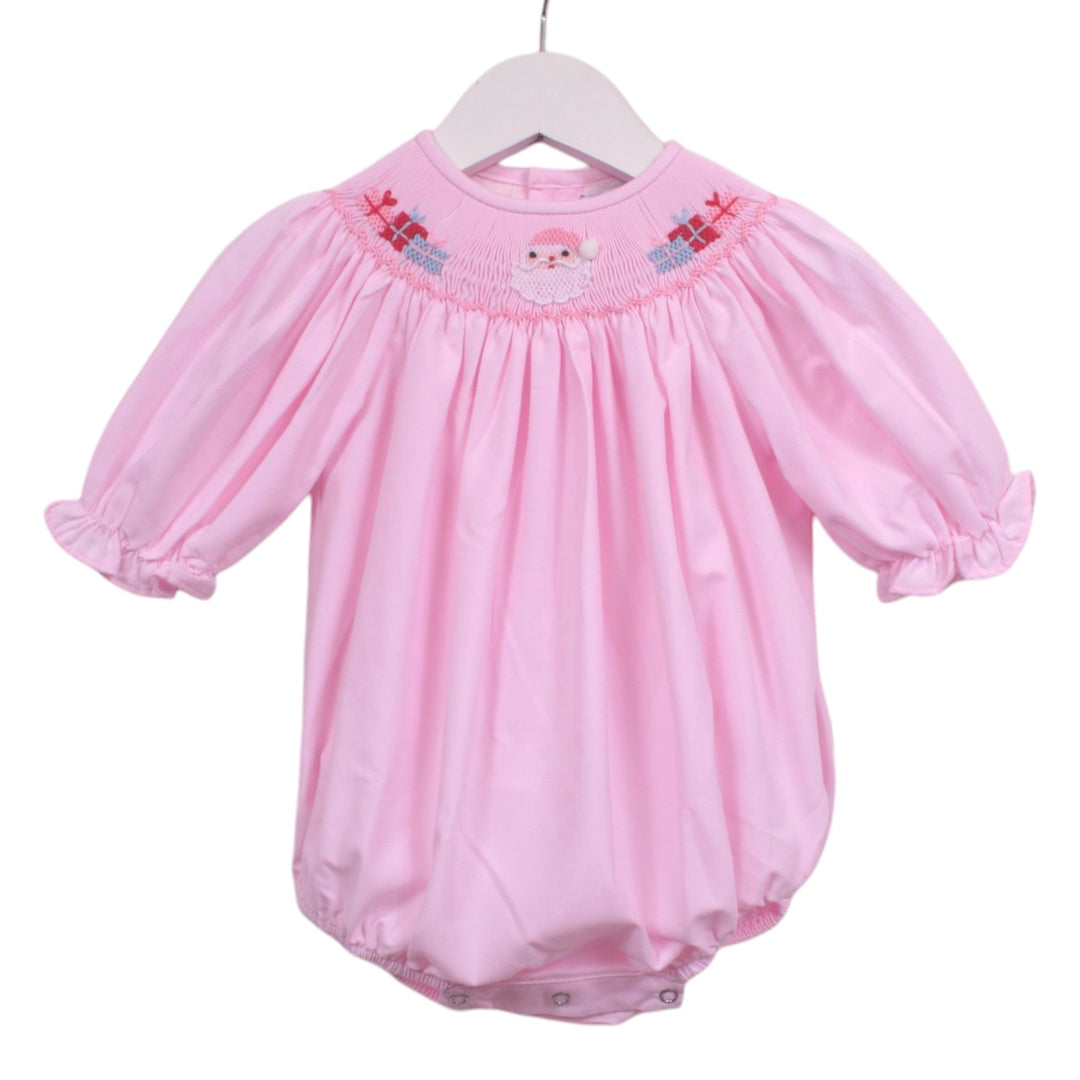 That Store pink girls bubble with smocked Santa and presents embroidery and ruffled sleeves on a white hanger