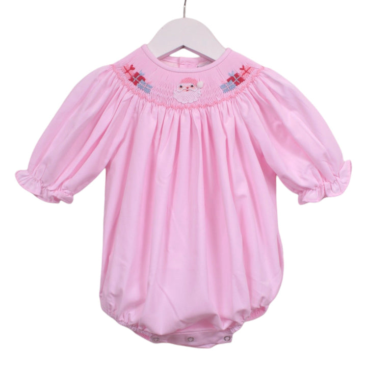 That Store pink girls bubble with smocked Santa and presents embroidery and ruffled sleeves on a white hanger