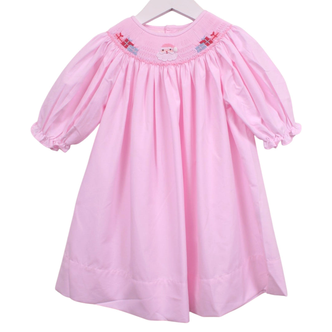 That Store pink bishop dress featuring smocked neckline with embroidered Santa Claus and Christmas presents.