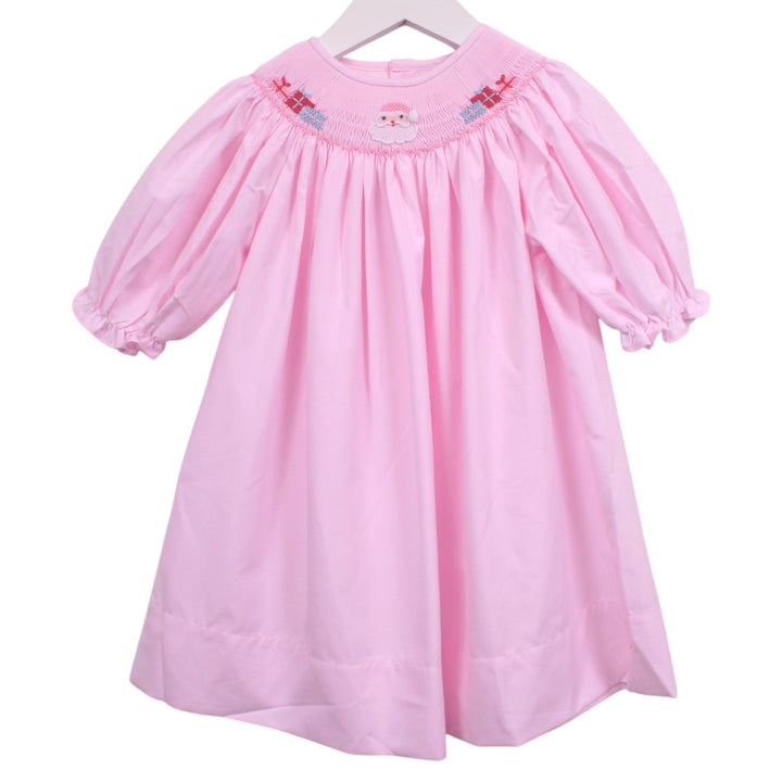 That Store pink bishop dress featuring smocked neckline with embroidered Santa Claus and Christmas presents.