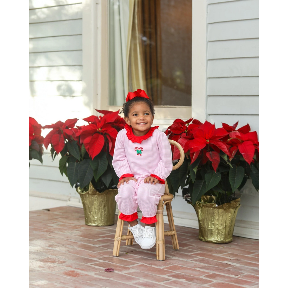 That Store pink stripe cotton romper with candy cane embroidery and red ruffles worn by a toddler for Christmas