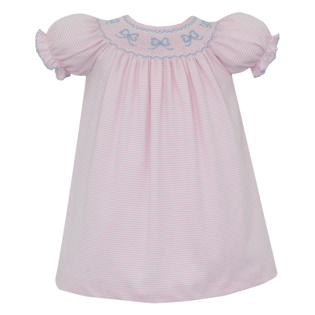 That Store pink striped cotton bishop dress with hand-smocked blue bows and puff sleeves for a classic look.