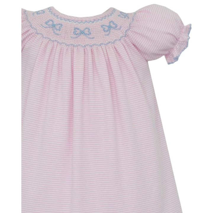 That Store pink and white striped cotton bishop dress with blue hand-smocked bow details and puff sleeves.