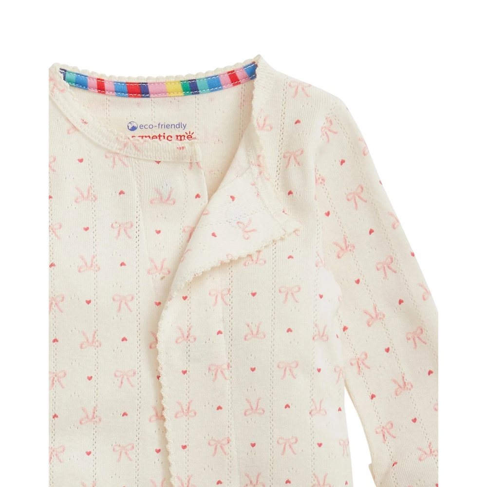 That Store organic cotton pointelle baby footie with pink heart and bow print and magnetic closures
