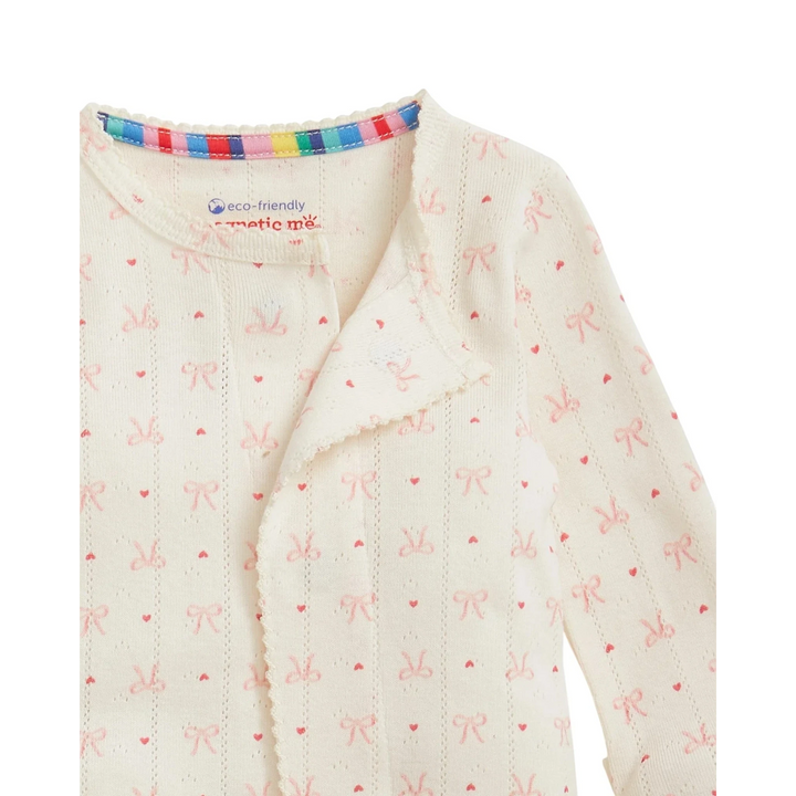 That Store organic cotton pointelle baby footie with pink heart and bow print and magnetic closures