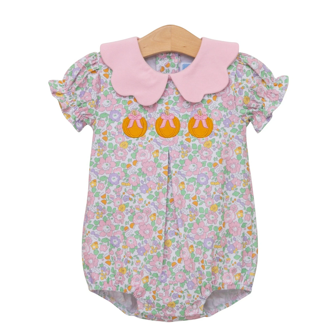 That Store girls bubble featuring a pink scalloped collar and pumpkin appliqué on a floral cotton blend fabric