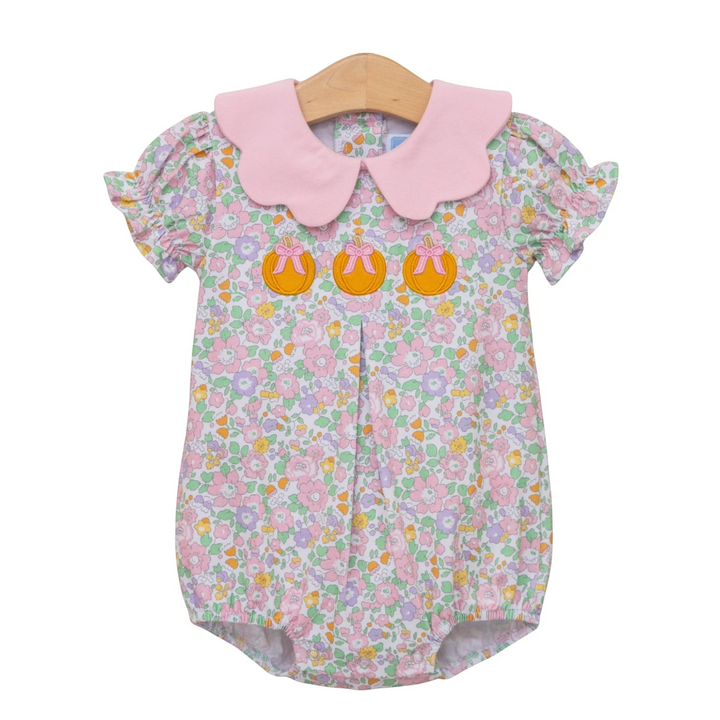 That Store girls bubble featuring a pink scalloped collar and pumpkin appliqué on a floral cotton blend fabric