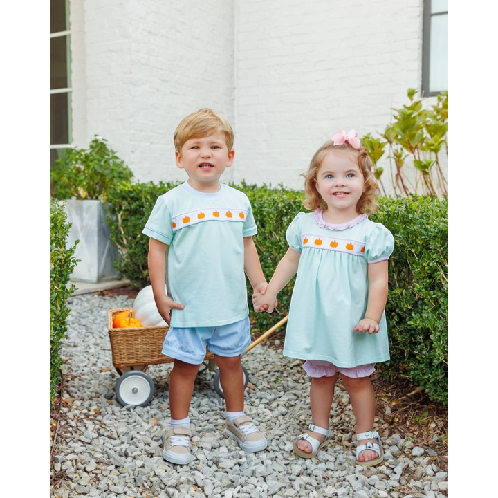 That Store Pumpkin Rowe mint and pink cotton bloomer set worn by a toddler girl and boy in a garden setting.