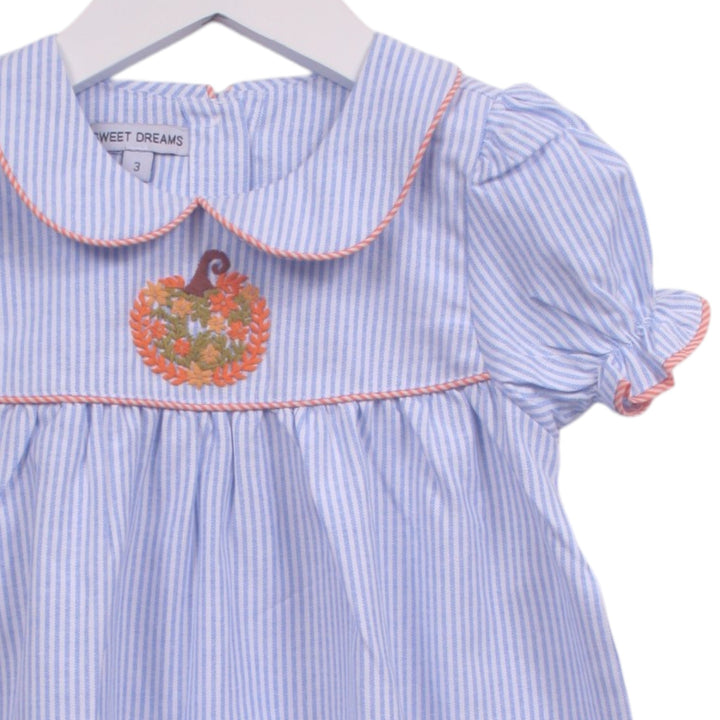 That Store blue and white pinstripe dress with pumpkin embroidery, Peter Pan collar, and orange piping details.