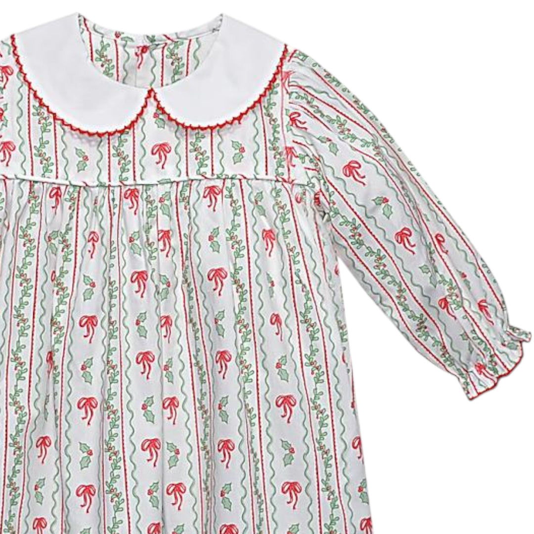 That Store girls Reagan dress in white cotton with red bows and green berries print and a white peter pan collar