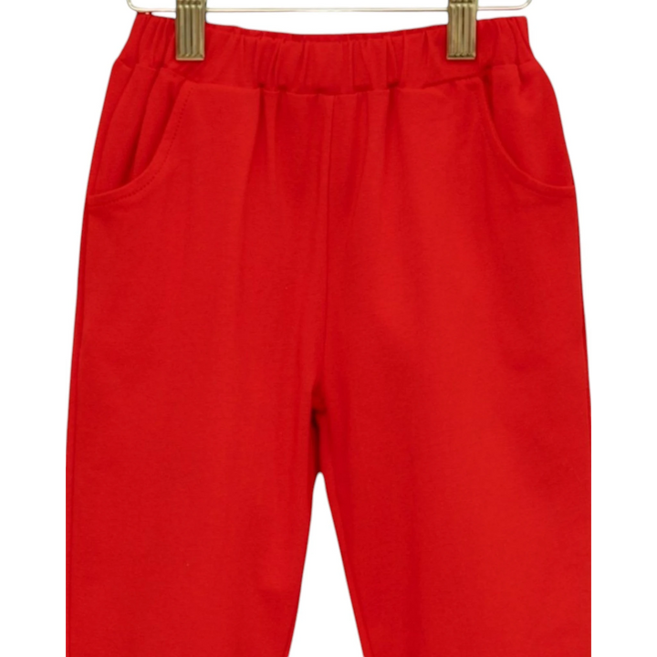 That Store red joggers for boys with an elastic waistband and side pockets, made from soft breathable fabric.