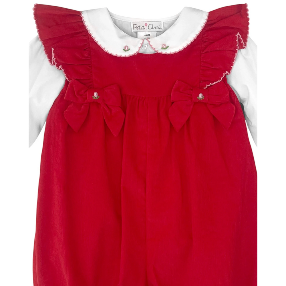 That Store red corduroy girls romper with white ruffle collar, long sleeves, and decorative bows for holiday wear.
