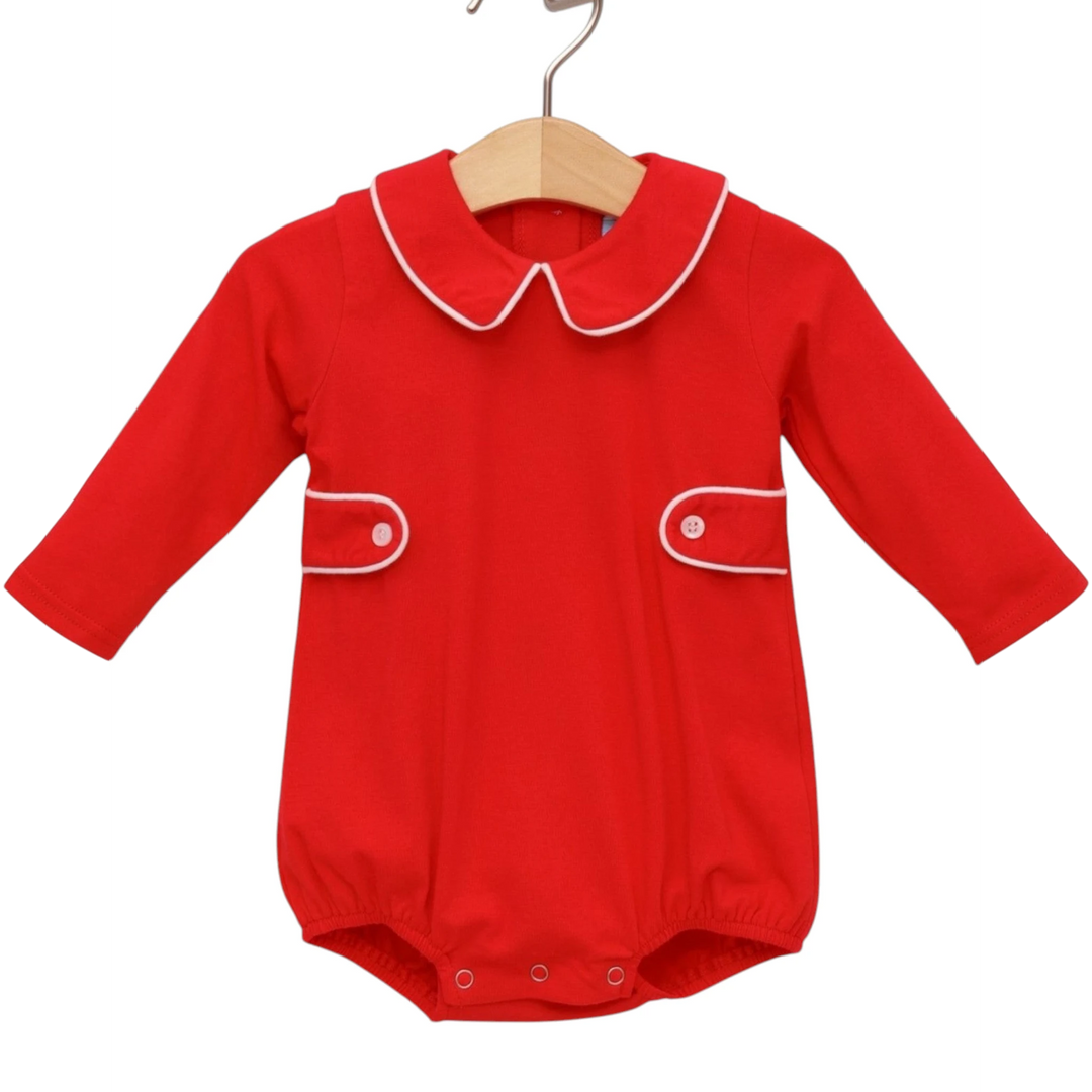 That Store red cotton bubble romper with white piping, Peter Pan collar, and long sleeves on a wooden hanger