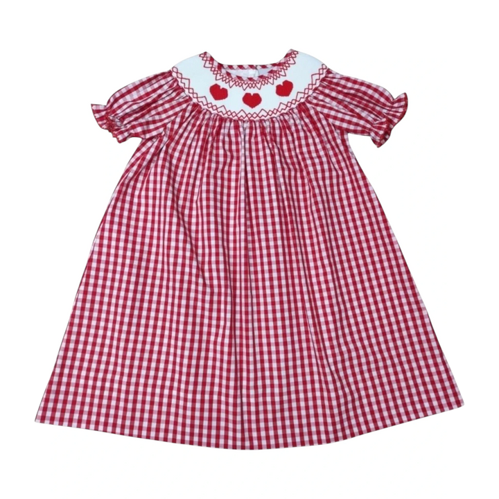 That Store red gingham dress for girls featuring a white collar with smocked red hearts and short puff sleeves.