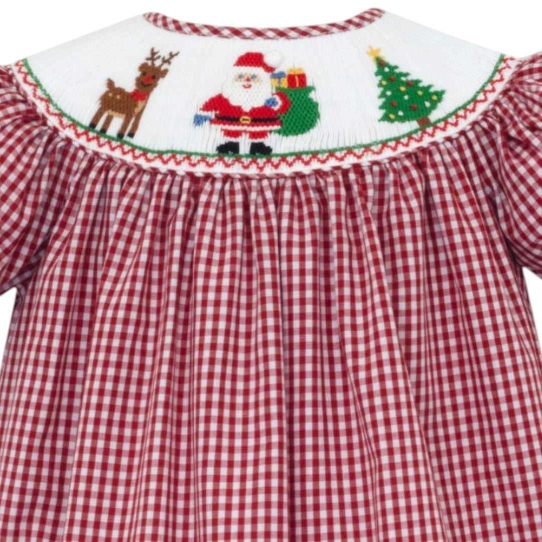 That Store red gingham bishop dress for girls featuring a smocked Santa, reindeer, and Christmas tree design.