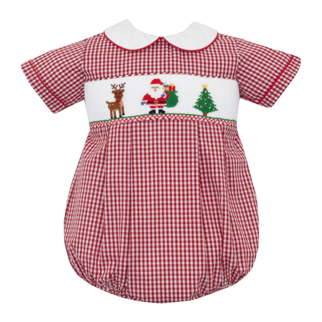 That Store boys bubble in red gingham featuring a white Peter Pan collar and smocked Santa, reindeer, and tree.