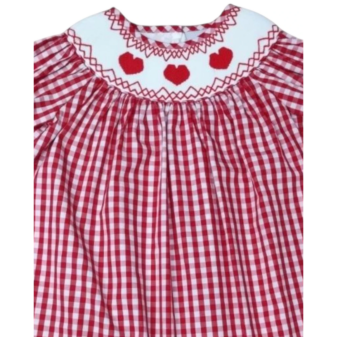 That Store red gingham dress featuring a white smocked collar with embroidered red hearts and puff sleeves.