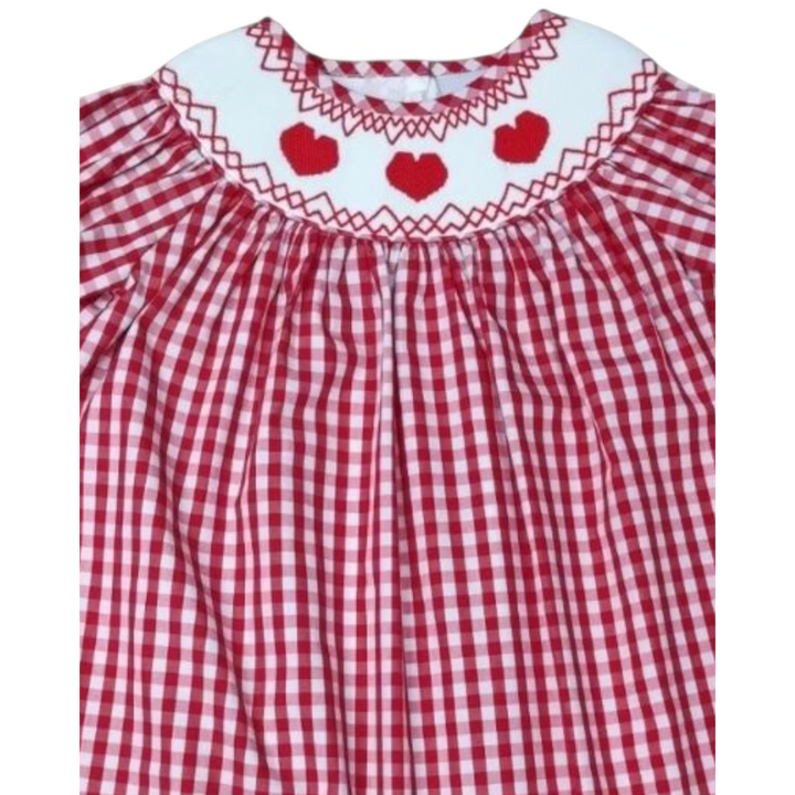 That Store red gingham dress featuring a white smocked collar with embroidered red hearts and puff sleeves.