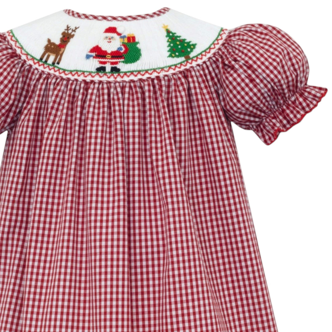 That Store girls red gingham bishop dress featuring traditional smocking with Santa, reindeer, and Christmas tree