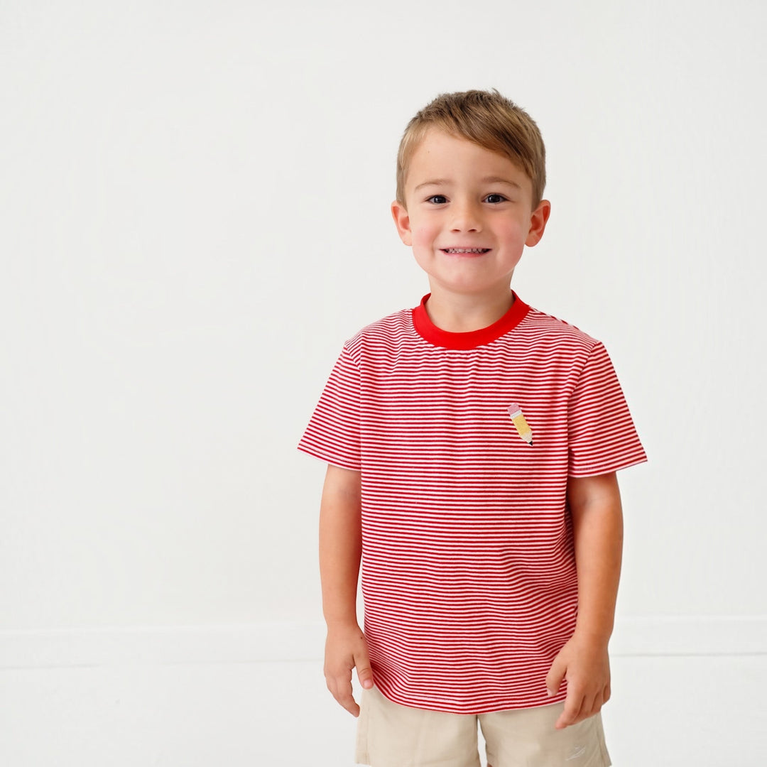 Young boy wearing a That Store red and white striped cotton t-shirt with a small embroidered pencil detail.