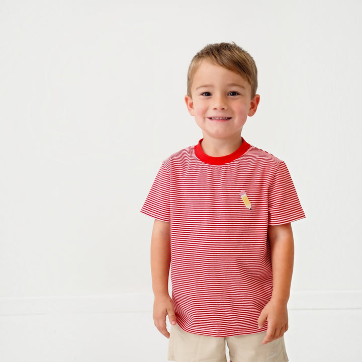 Young boy wearing a That Store red and white striped cotton t-shirt with a small embroidered pencil detail.