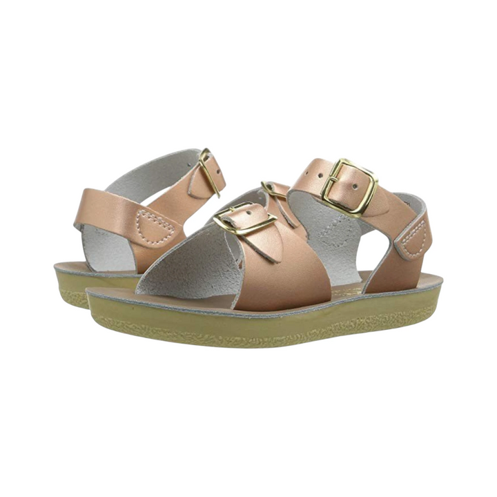 That Store rose gold water-friendly leather surfer sandals for girls with adjustable brass buckle straps.
