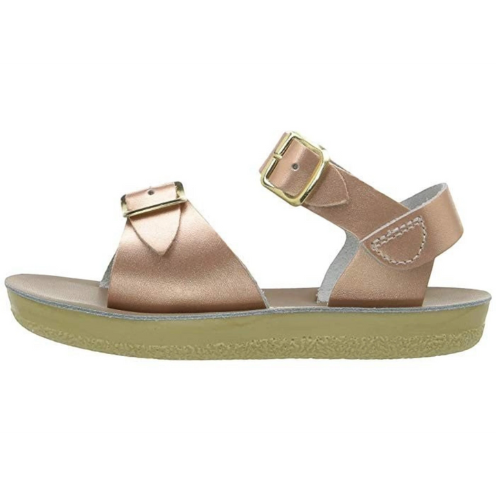 That Store rose gold water-friendly leather surfer sandals with two adjustable buckle straps and a flexible outsole.