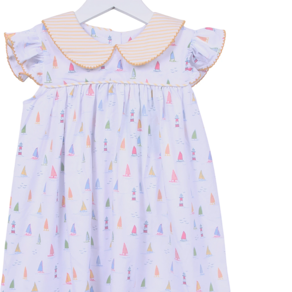 That Store white cotton dress with sailboat print, yellow striped Peter Pan collar, and angel wing sleeves.