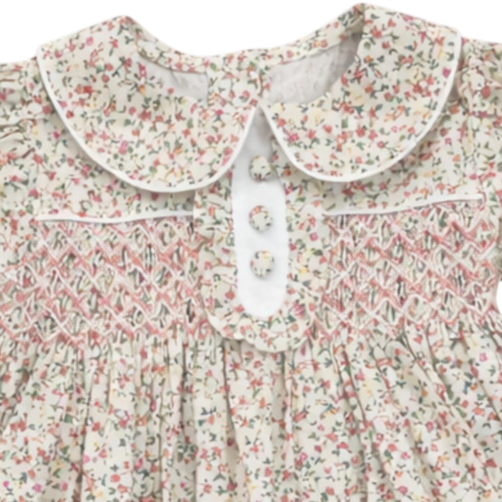 That Store girls Samantha floral cotton dress with classic chest smocking, white collar, and three-button placket.