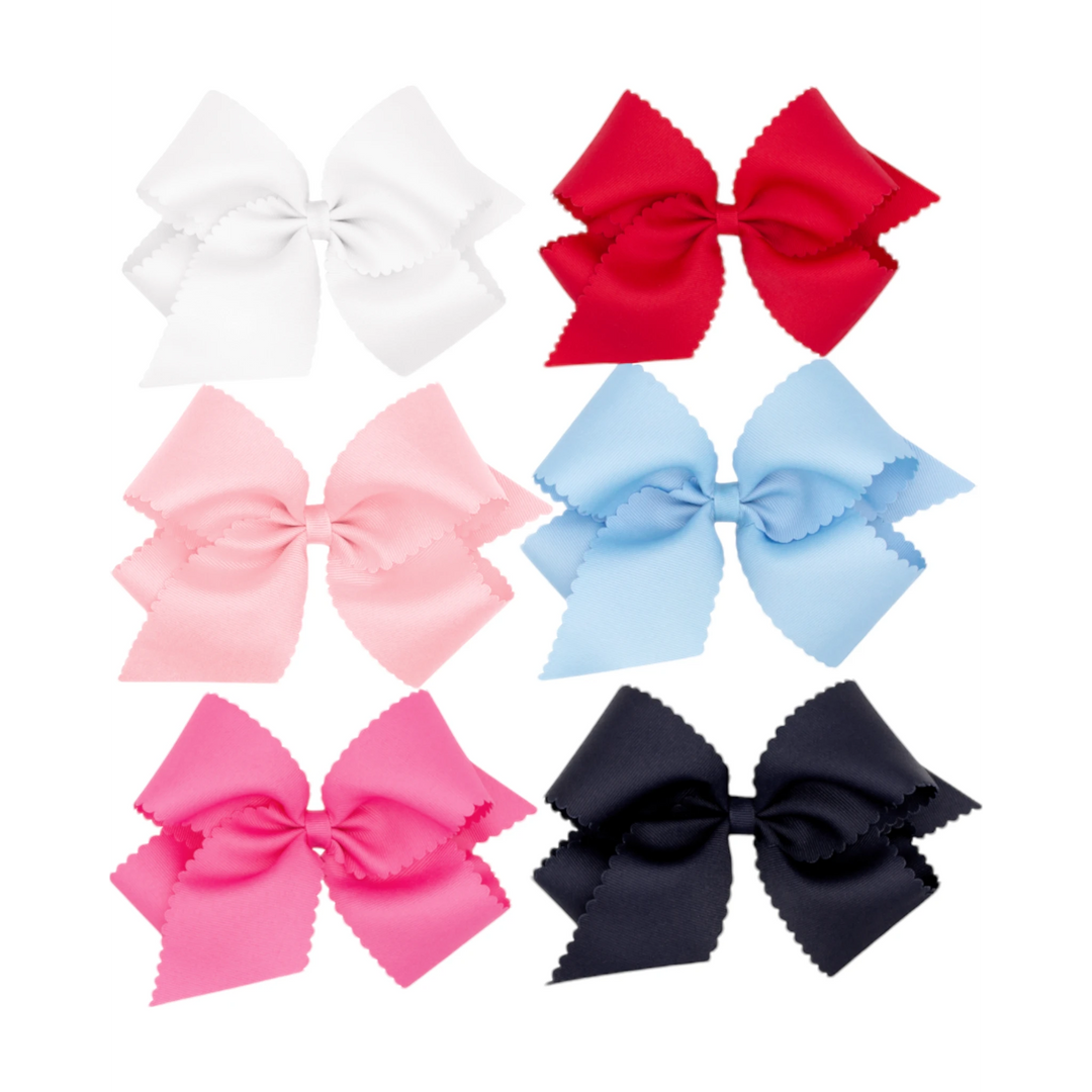 That Store collection of six colorful grosgrain hair bows for girls featuring scalloped edges and secure clips.
