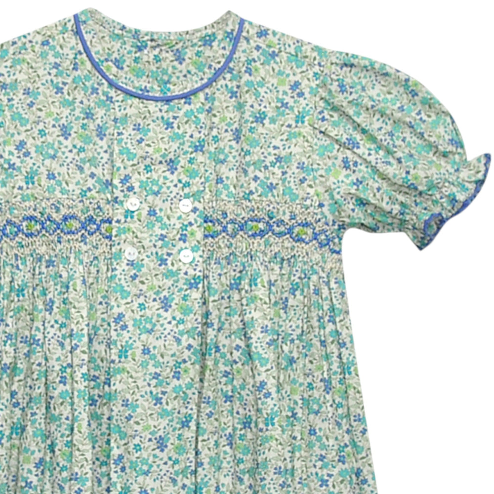 That Store smocked blue floral dress with puff sleeves, blue piping, and a vintage-inspired double-breasted button front