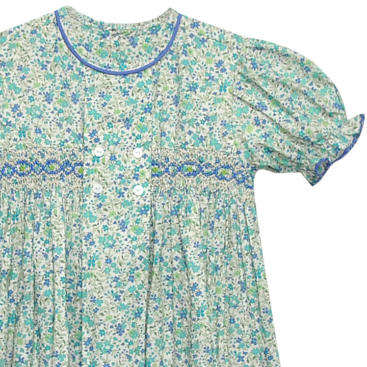 That Store smocked blue floral dress with puff sleeves, blue piping, and a vintage-inspired double-breasted button front
