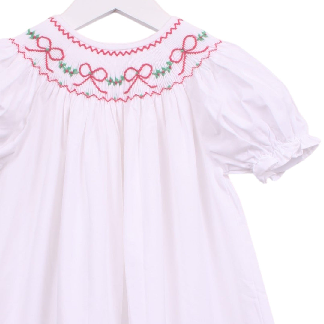 That Store white girls bubble with red smocked bows and green garland embroidery, featuring puff sleeves.