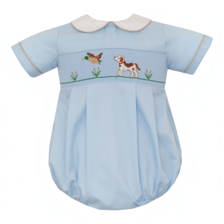 That Store blue boys bubble with smocked hunting dog and mallard embroidery, featuring khaki gingham trim.