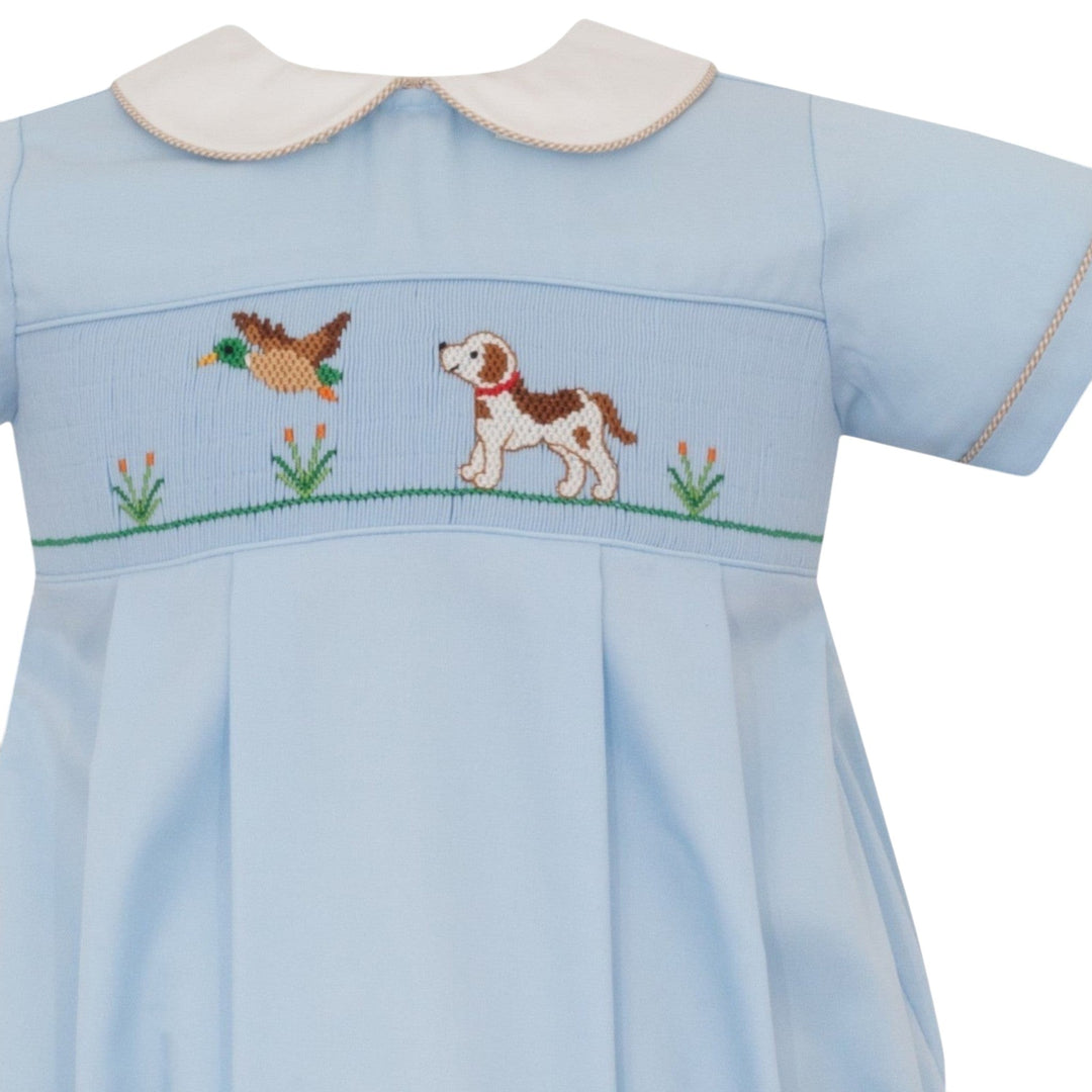 That Store boys blue bubble with smocked hunting dog and mallard embroidery, featuring khaki gingham trim.