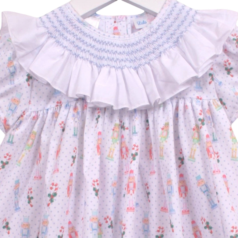 That Store girls smocked bloomer set with white ruffled collar and blue nutcracker print on a white dotted fabric