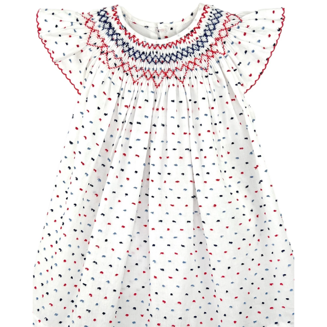 That Store smocked cotton bishop dress in white with red and blue dot pattern and angel wing sleeves